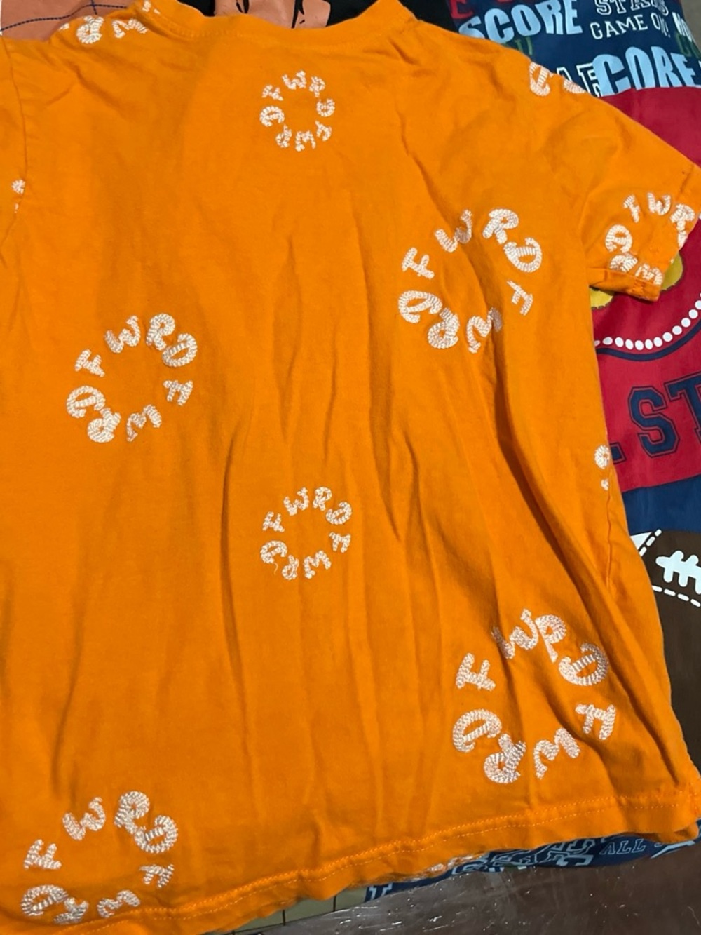 Denim Tears Bright Orange Short-Sleeve Tee with White Spiral Lettering